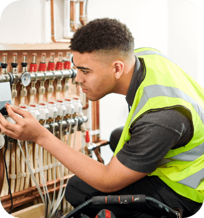 Man adjusting a plumbing controller